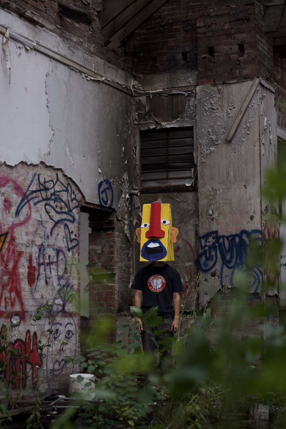 In the Midst of the Broken — mask standing in doorway
